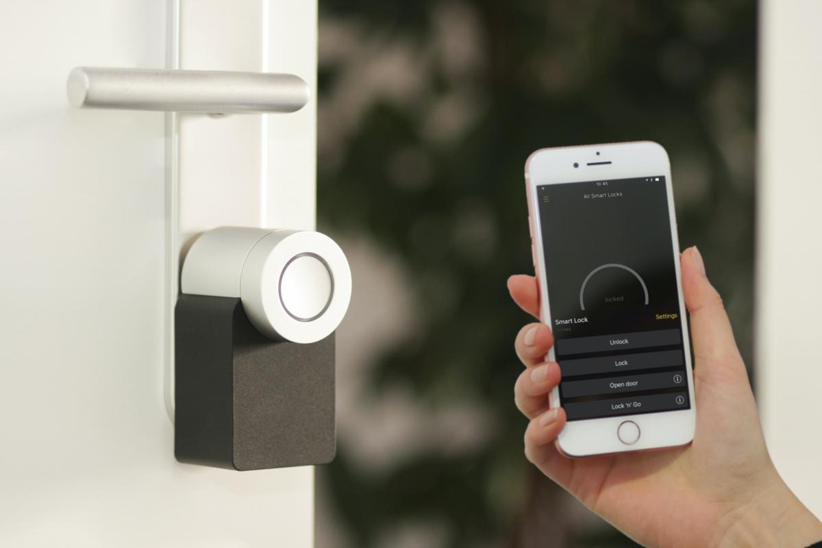 smart phone held up to a smart door lock